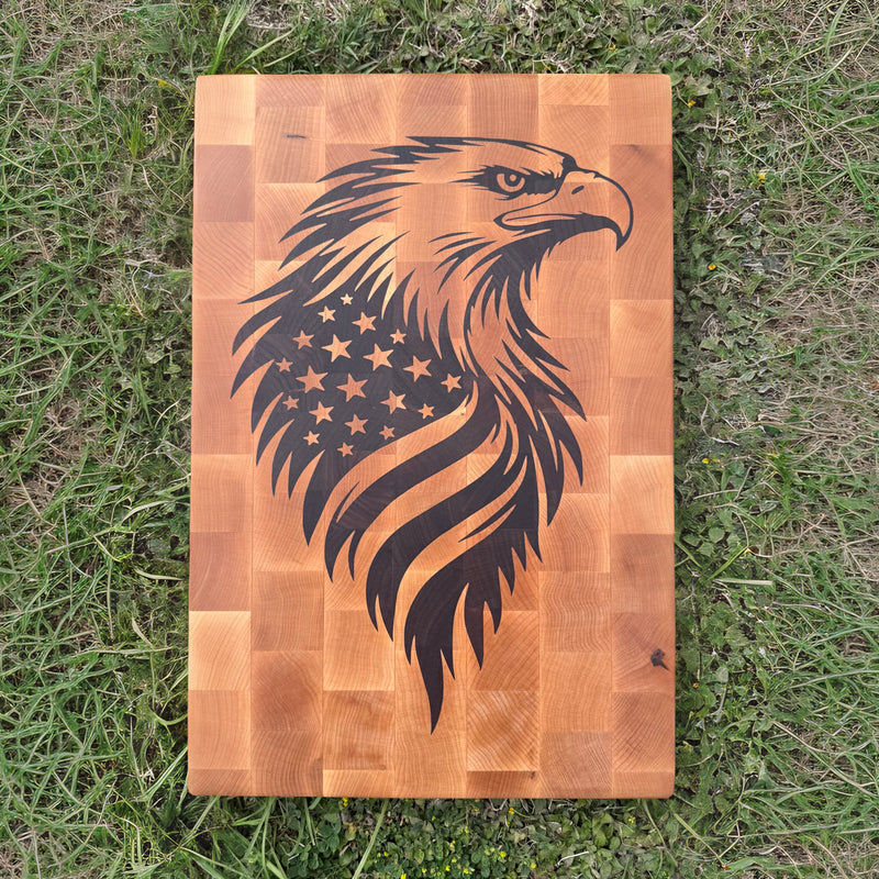Wooden cutting board with an eagle and American flag design on a grassy background