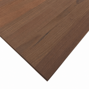 Close-up of a Peruvian walnut wood panel showing its brown tones, grain patterns, and unfinished surface.