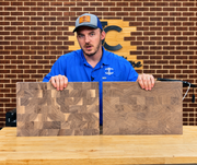 Video over the difference between two walnut end grain cutting boards. the video has 2 boards sitting on a table with a brick backdrop behind it. 

